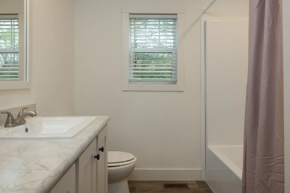 The HEY JUDE Guest Bathroom. This Manufactured Mobile Home features 4 bedrooms and 2 baths.