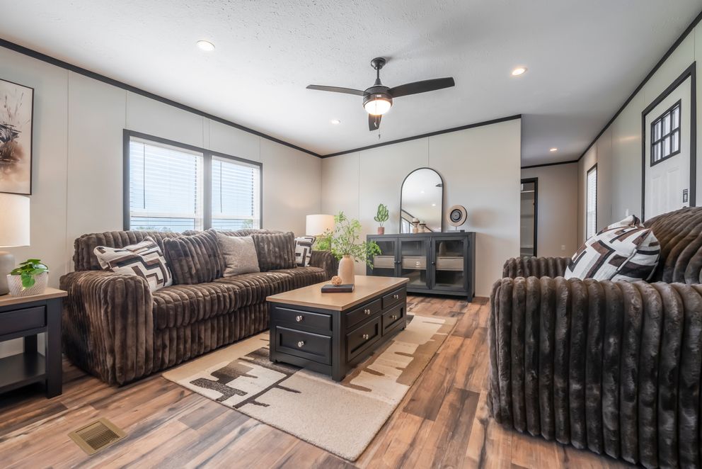 The RAVENWOOD Living Room. This Manufactured Mobile Home features 3 bedrooms and 2 baths.
