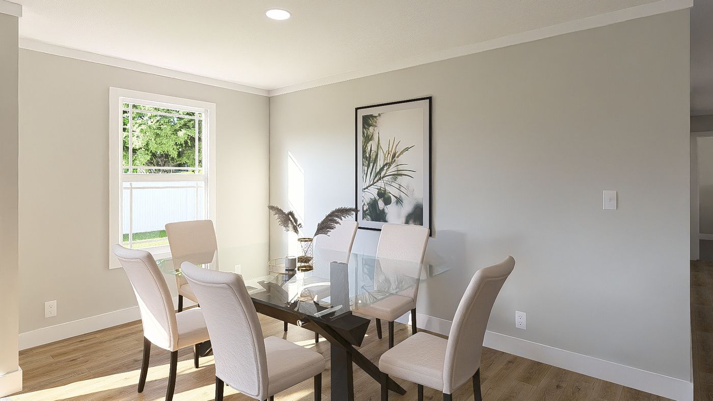 The THE BREEZE 64 Dining Area. This Manufactured Mobile Home features 4 bedrooms and 2 baths.