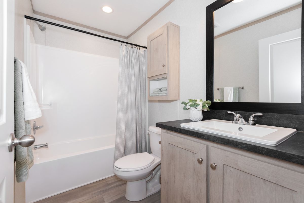The 5628-5202 ADRENALINE Guest Bathroom. This Manufactured Mobile Home features 3 bedrooms and 2 baths.