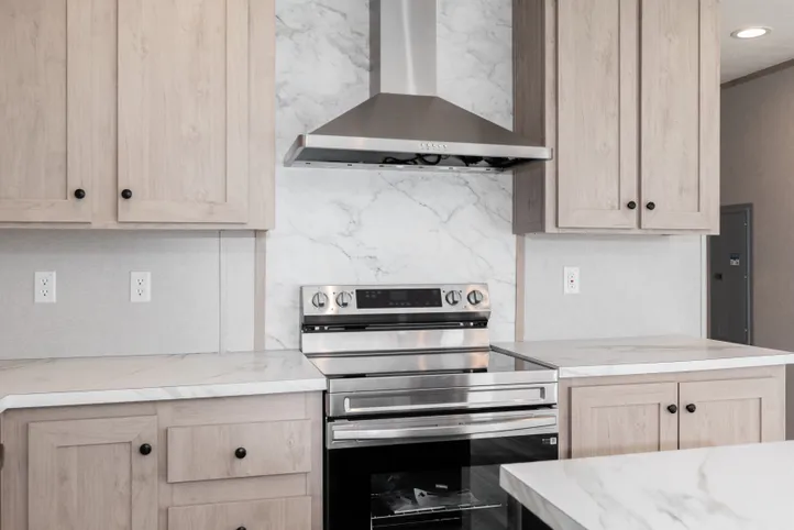 The THE ANNIVERSARY ISLANDER Kitchen. This Manufactured Mobile Home features 3 bedrooms and 2 baths.