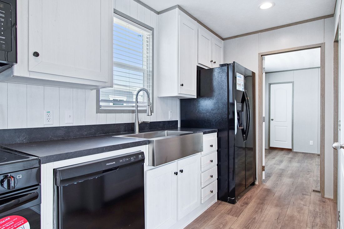 The ANNIVERSARY 16682A Kitchen. This Manufactured Mobile Home features 2 bedrooms and 2 baths.