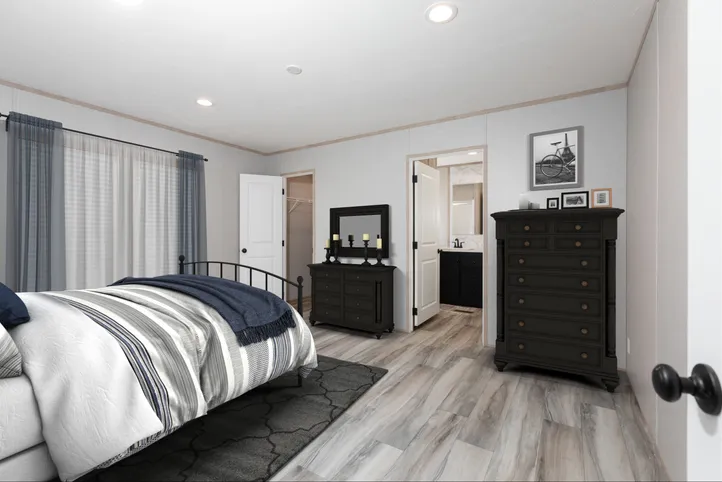 The THE ANNIVERSARY ISLANDER Primary Bedroom. This Manufactured Mobile Home features 3 bedrooms and 2 baths.