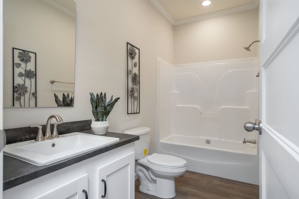 The 1533 THE BROOK HUD Guest Bathroom. This Manufactured Mobile Home features 3 bedrooms and 2 baths.