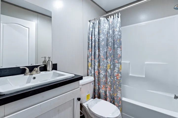 The RESOLUTION 16763J Guest Bathroom. This Manufactured Mobile Home features 3 bedrooms and 2 baths.