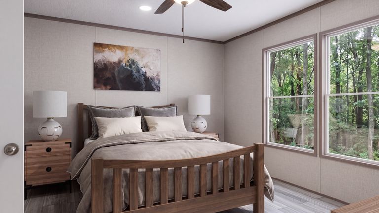 The THE MOUNTAINEER 60 Primary Bedroom. This Manufactured Mobile Home features 3 bedrooms and 2 baths.