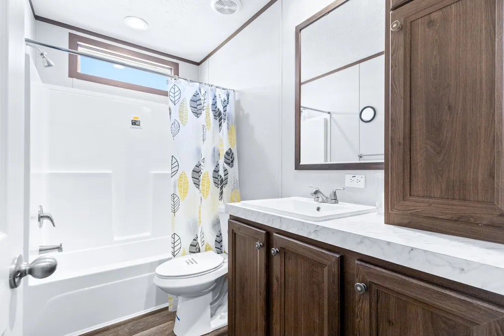 The THE SUNDOWNER Guest Bathroom. This Manufactured Mobile Home features 3 bedrooms and 2 baths.