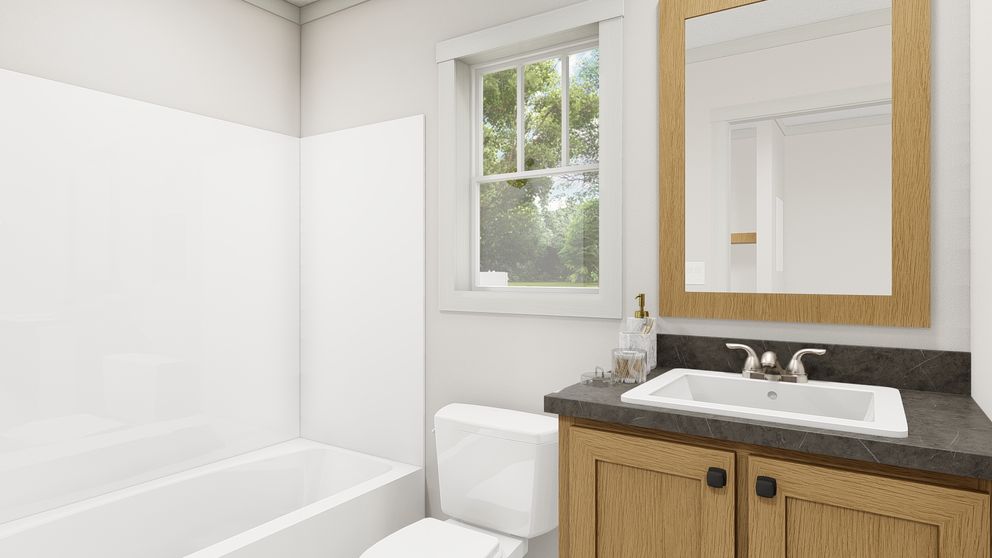 The GOOD VIBRATIONS Guest Bathroom. This Manufactured Mobile Home features 3 bedrooms and 2 baths.