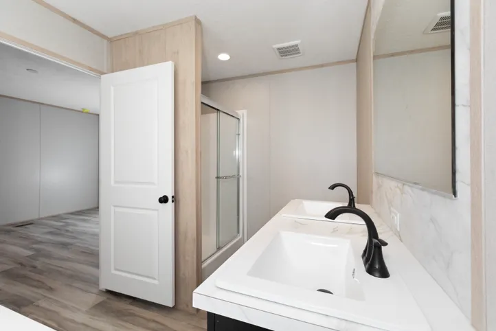 The THE ANNIVERSARY ISLANDER Primary Bathroom. This Manufactured Mobile Home features 3 bedrooms and 2 baths.