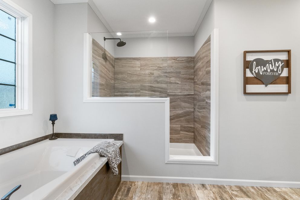 The THE BRYANT Primary Bathroom. This Manufactured Mobile Home features 4 bedrooms and 2 baths.