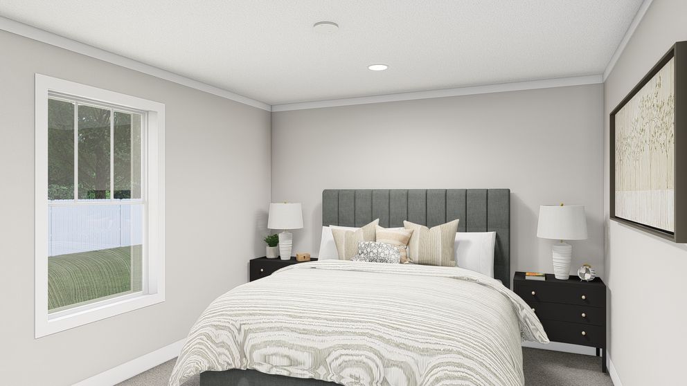 The HERE COMES THE SUN Primary Bedroom. This Manufactured Mobile Home features 3 bedrooms and 2 baths.