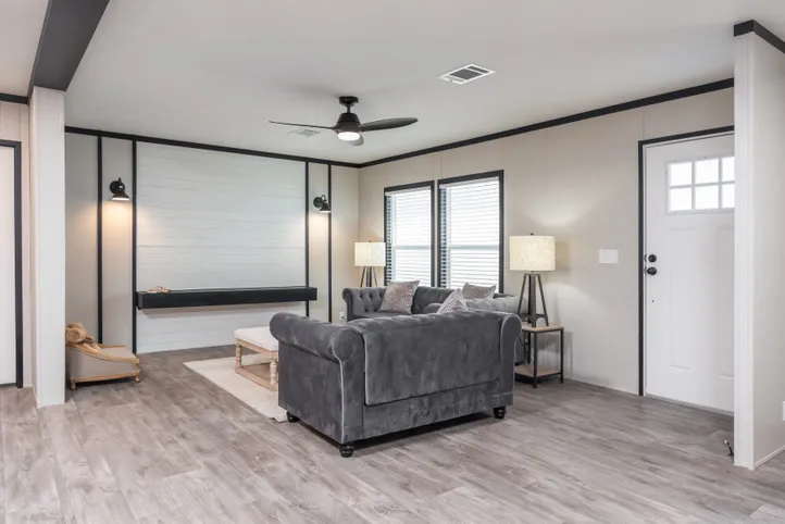 The BREEZE FARMHOUSE Living Room. This Manufactured Mobile Home features 3 bedrooms and 2 baths.