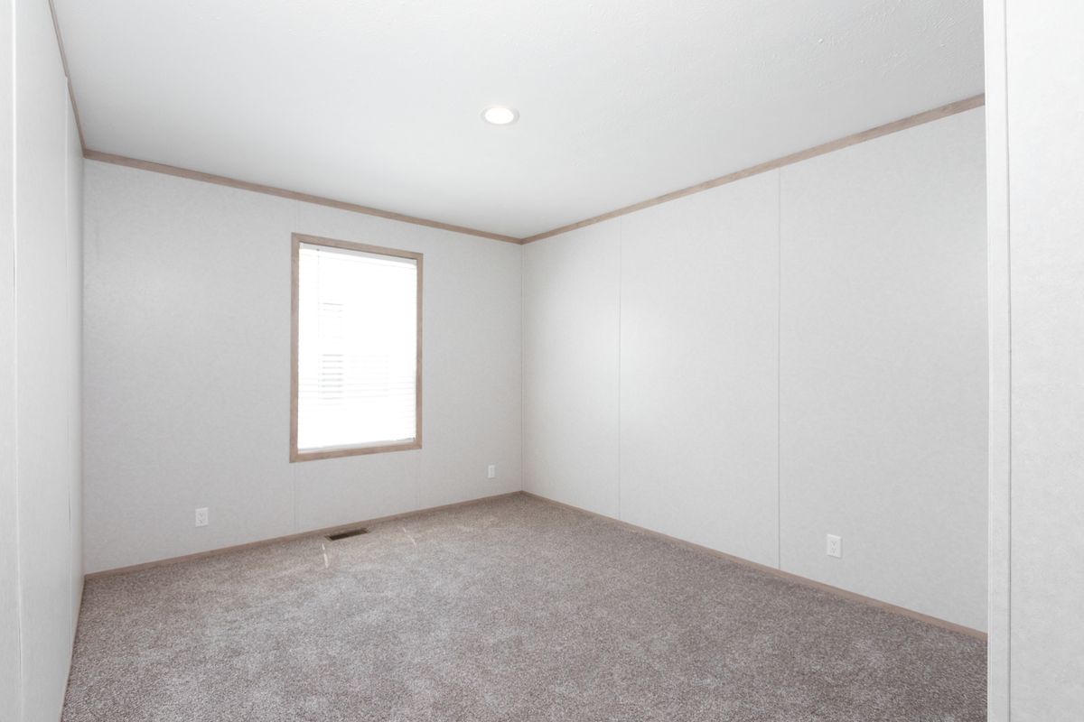 The 6032-5700 THE PULSE Guest Bedroom. This Manufactured Mobile Home features 3 bedrooms and 2 baths.
