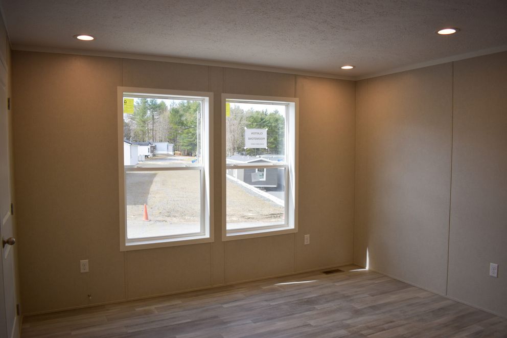 The MOONSTONE 60 Primary Bedroom. This Manufactured Mobile Home features 3 bedrooms and 2 baths.
