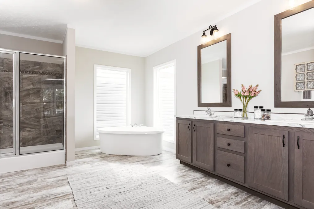 The COUNTRY AIRE Primary Bathroom. This Manufactured Mobile Home features 3 bedrooms and 3 baths.