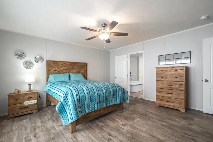 The THE FUSION 32B Primary Bedroom. This Manufactured Mobile Home features 4 bedrooms and 2 baths.