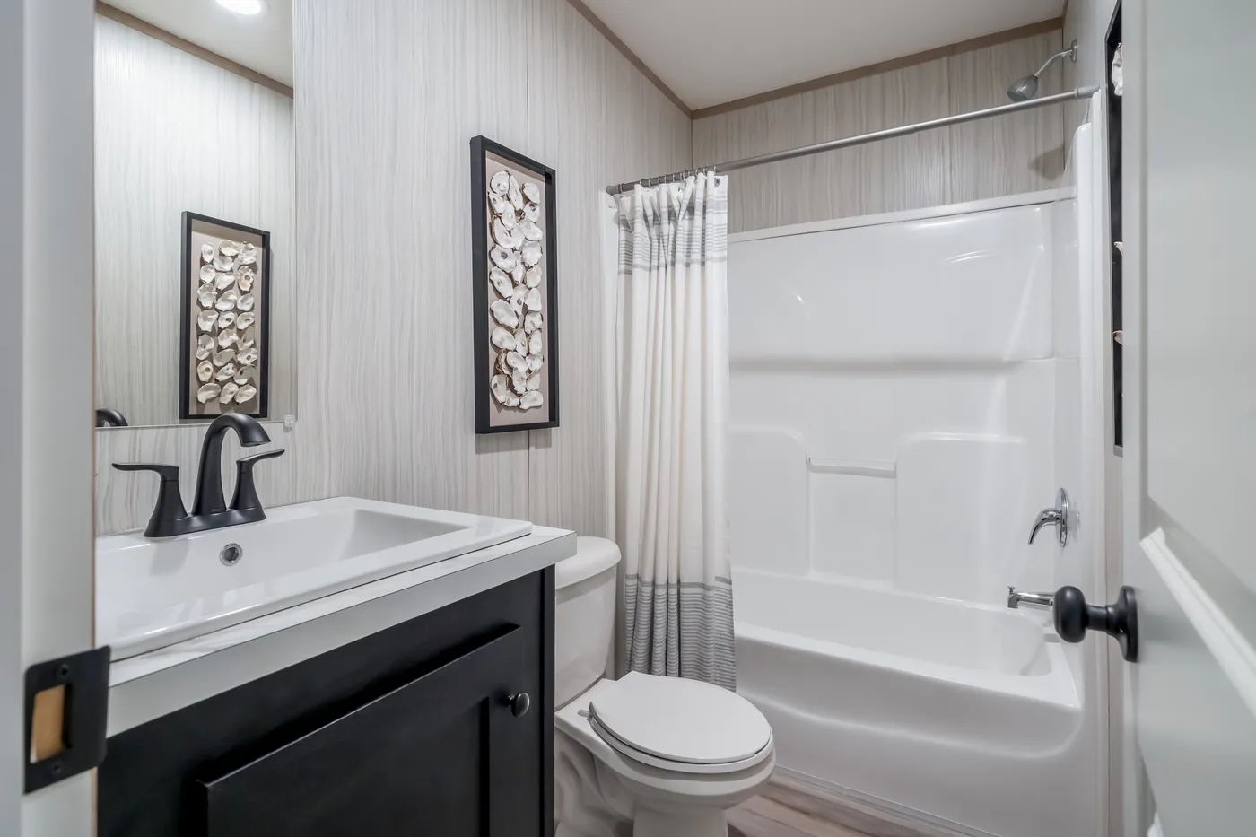 The ANNIVERSARY JEWEL Guest Bathroom. This Manufactured Mobile Home features 3 bedrooms and 2 baths.