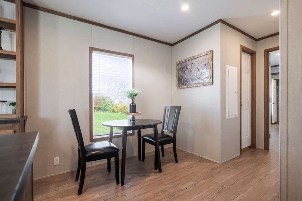 The SEAS THE DAY Dining Area. This Manufactured Mobile Home features 3 bedrooms and 2 baths.