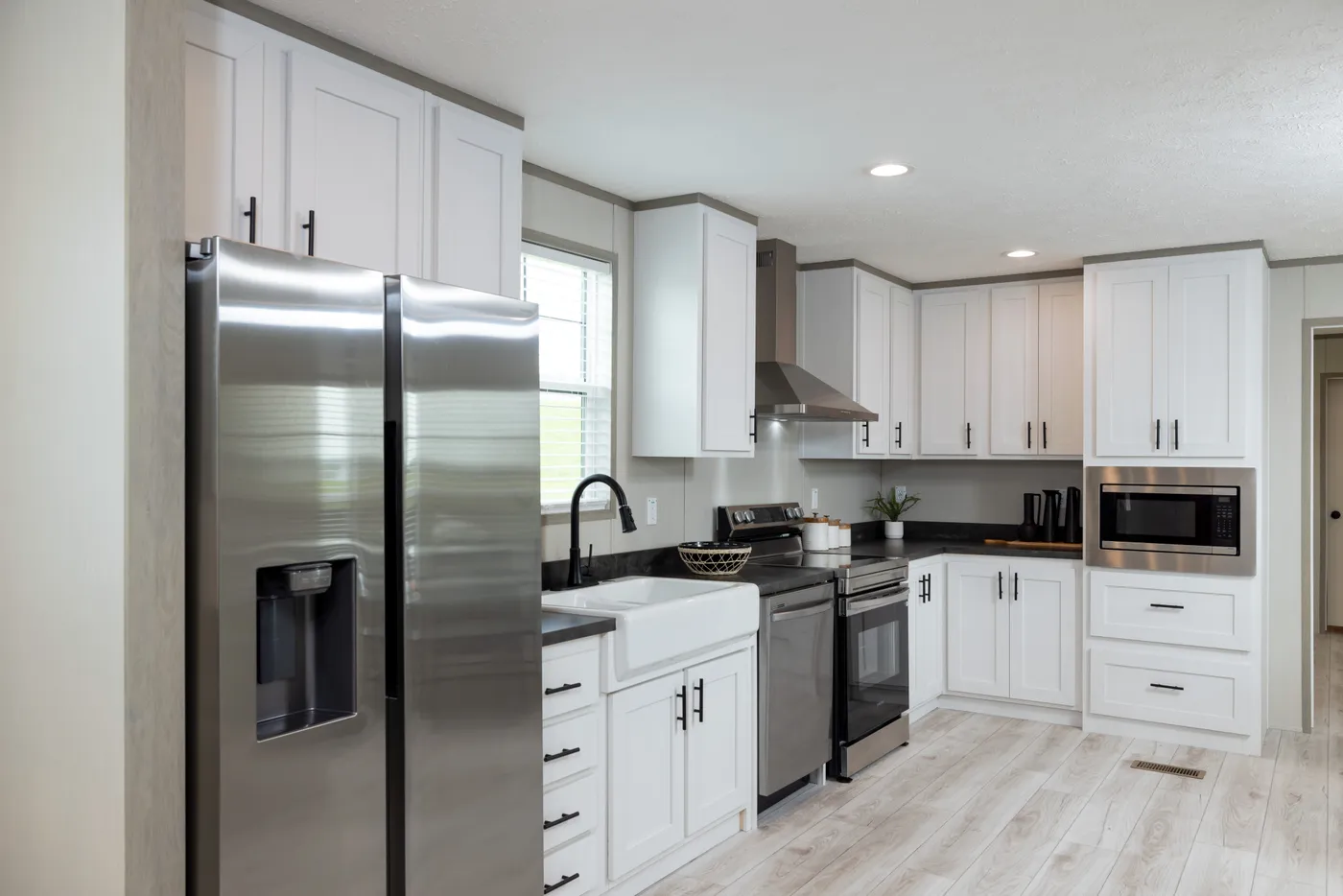 The SHOWER HOUSE Kitchen. This Manufactured Mobile Home features 3 bedrooms and 2 baths.