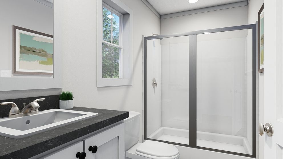 The BORN TO RUN Primary Bathroom. This Manufactured Mobile Home features 2 bedrooms and 2 baths.