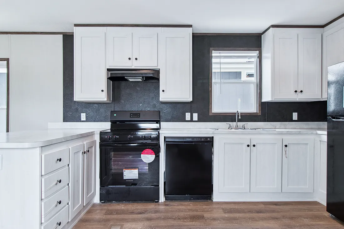 The HOMESTEAD 16562A Kitchen. This Manufactured Mobile Home features 2 bedrooms and 2 baths.