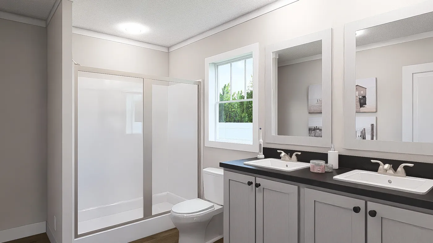 The THREE LITTLE BIRDS Primary Bathroom. This Manufactured Mobile Home features 3 bedrooms and 2 baths.