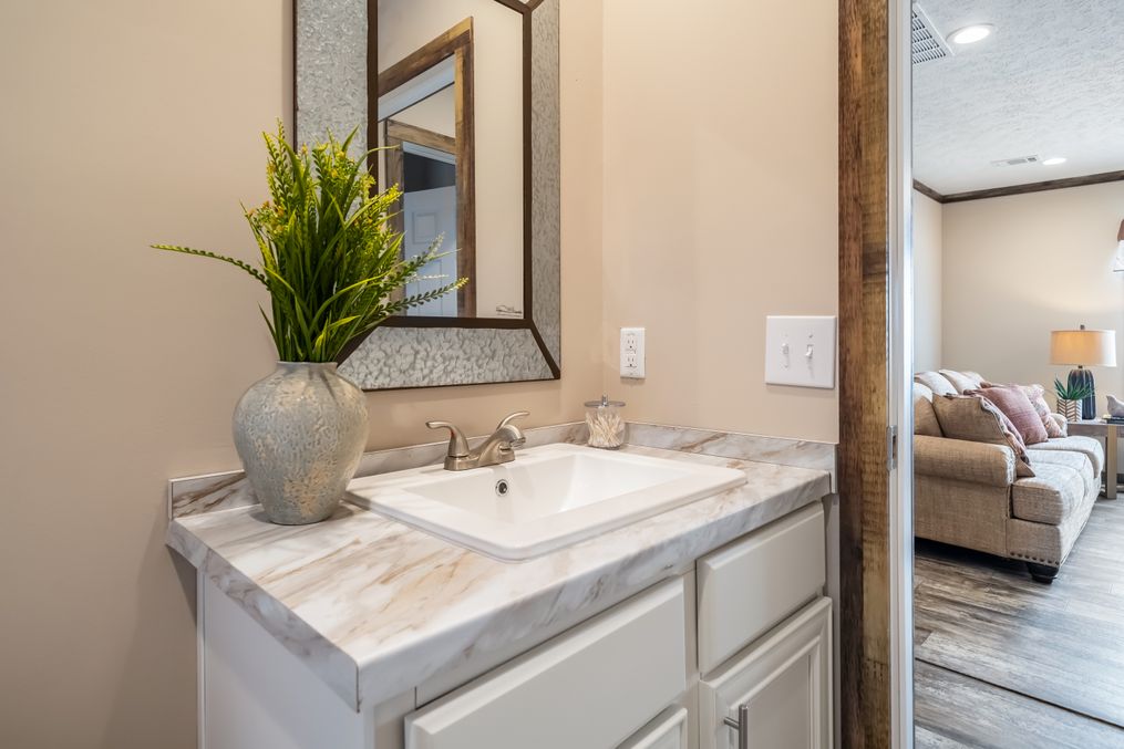 The THE TYRA Guest Bathroom. This Manufactured Mobile Home features 4 bedrooms and 2 baths.