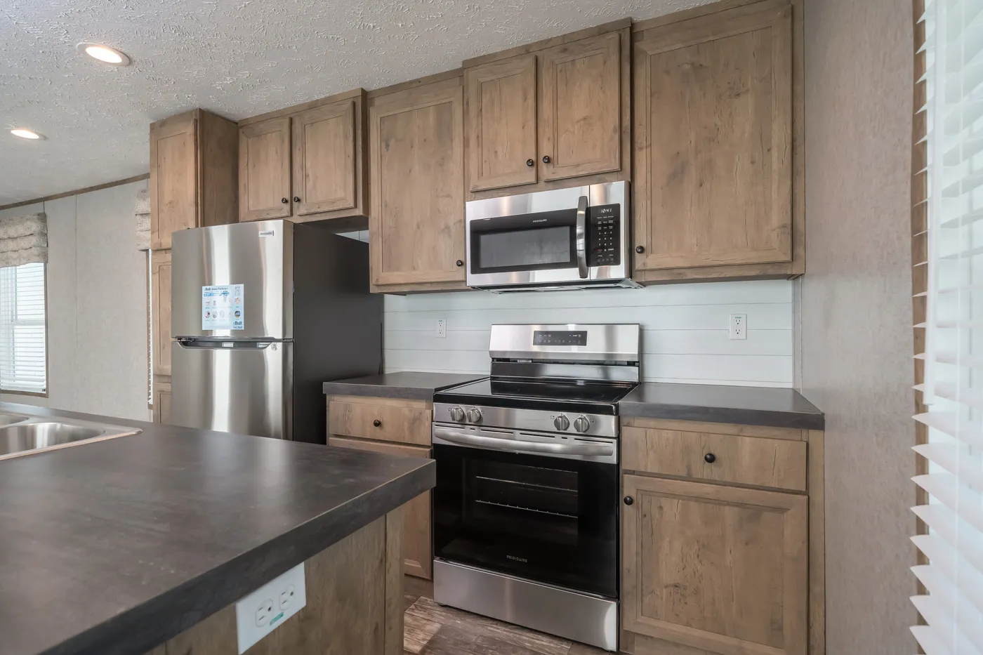 The LAKESIDE COTTAGE Kitchen. This Manufactured Mobile Home features 1 bedroom and 1 bath.