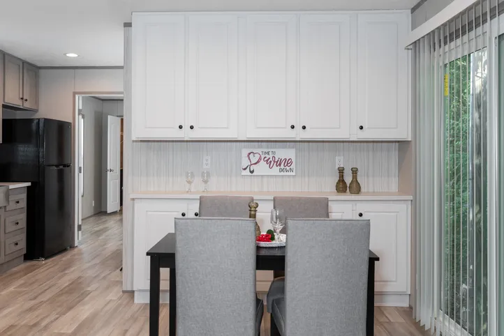 The THE ANNIVERSARY 76 Dining Area. This Manufactured Mobile Home features 3 bedrooms and 2 baths.