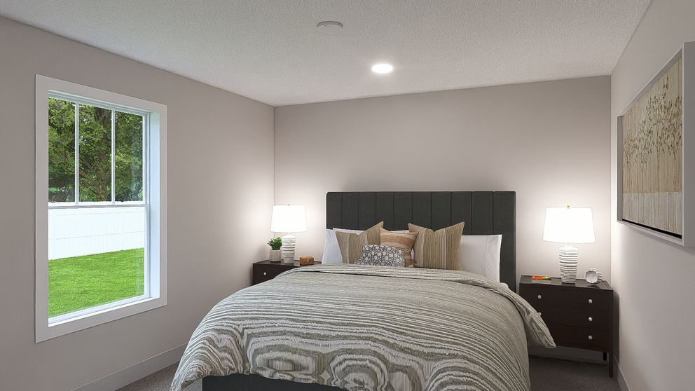 The HERE COMES THE SUN Primary Bedroom. This Manufactured Mobile Home features 3 bedrooms and 2 baths.