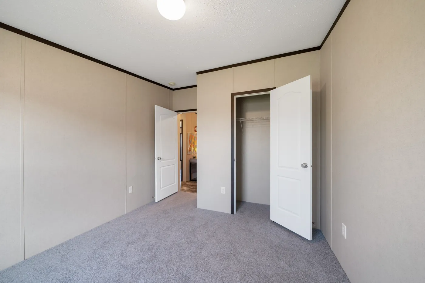 The GARNET Guest Bedroom. This Manufactured Mobile Home features 3 bedrooms and 2 baths.