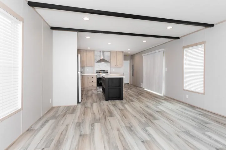 The THE ANNIVERSARY ISLANDER Living Room. This Manufactured Mobile Home features 3 bedrooms and 2 baths.