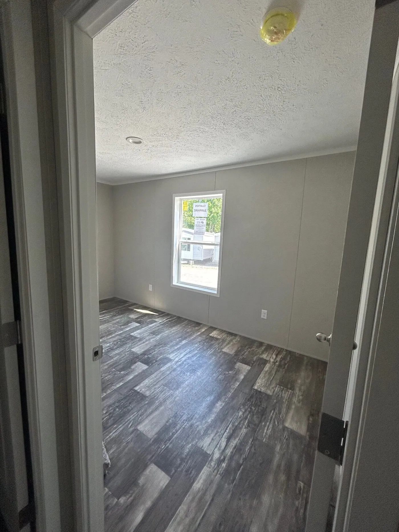 The SAPPHIRE XL 8016-644 Primary Bedroom. This Manufactured Mobile Home features 3 bedrooms and 2 baths.