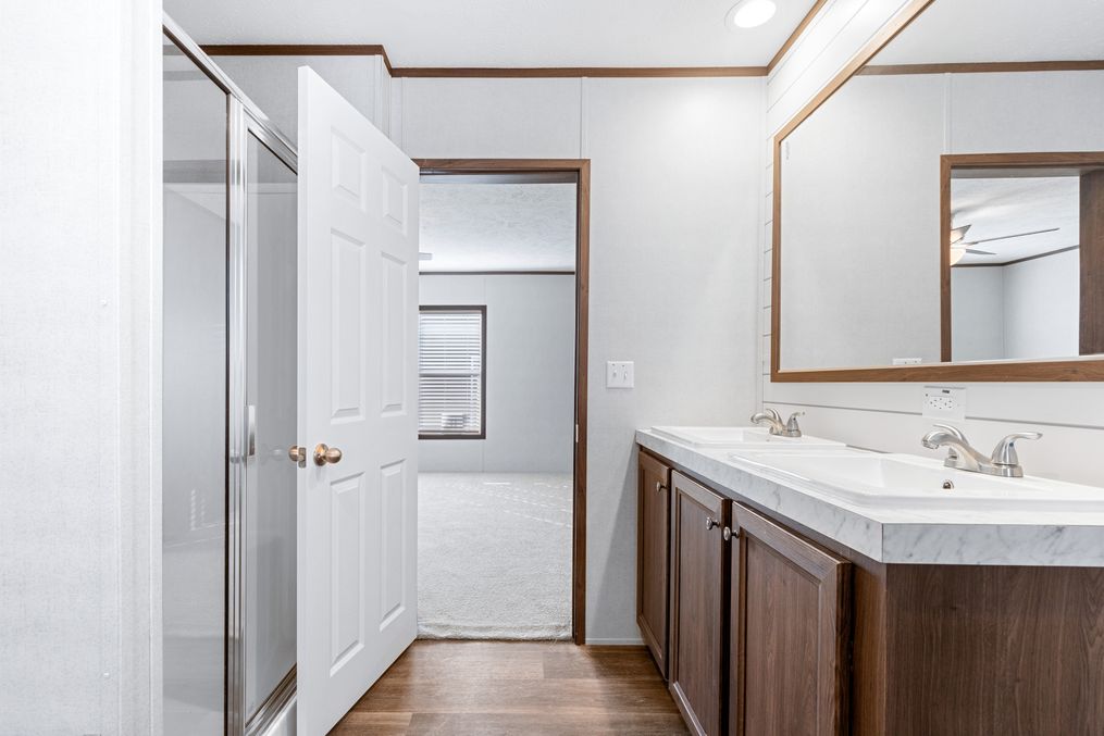 The THE SUNDOWNER Primary Bathroom. This Manufactured Mobile Home features 3 bedrooms and 2 baths.