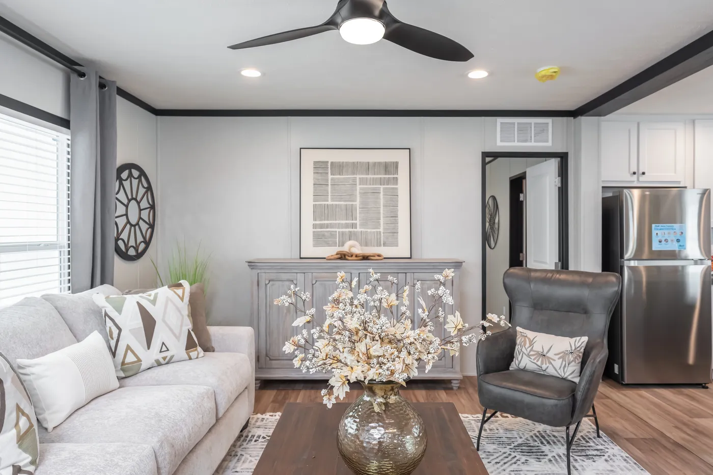 The ABSOLUTE VALUE Living Room. This Manufactured Mobile Home features 4 bedrooms and 2 baths.