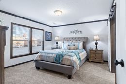 The BOUJEE XL Primary Bedroom. This Manufactured Mobile Home features 4 bedrooms and 3 baths.