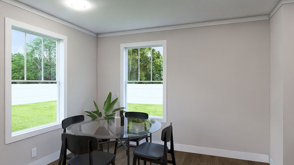 The THREE LITTLE BIRDS Dining Area. This Manufactured Mobile Home features 3 bedrooms and 2 baths.