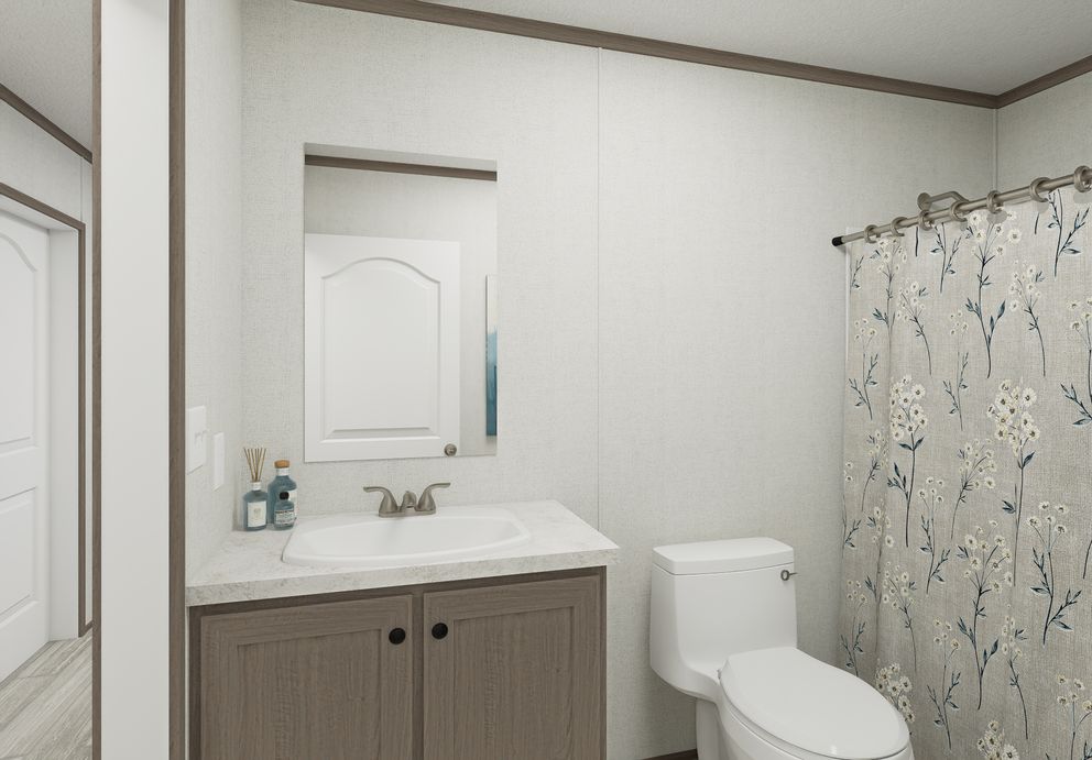 The THE MOUNTAINEER 64 Guest Bathroom. This Manufactured Mobile Home features 3 bedrooms and 2 baths.