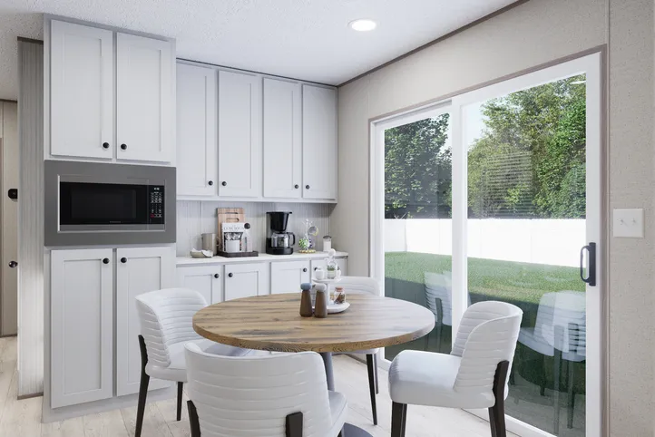The THE ANNIVERSARY 76 Dining Room. This Manufactured Mobile Home features 3 bedrooms and 2 baths.