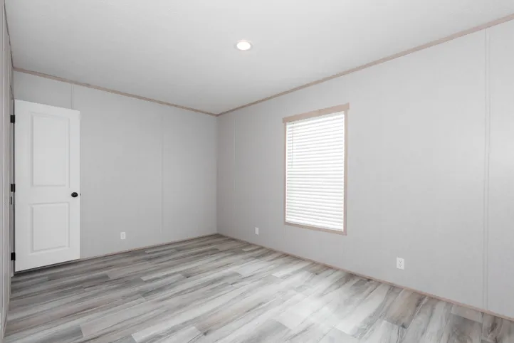The THE ANNIVERSARY ISLANDER Guest Bedroom. This Manufactured Mobile Home features 3 bedrooms and 2 baths.