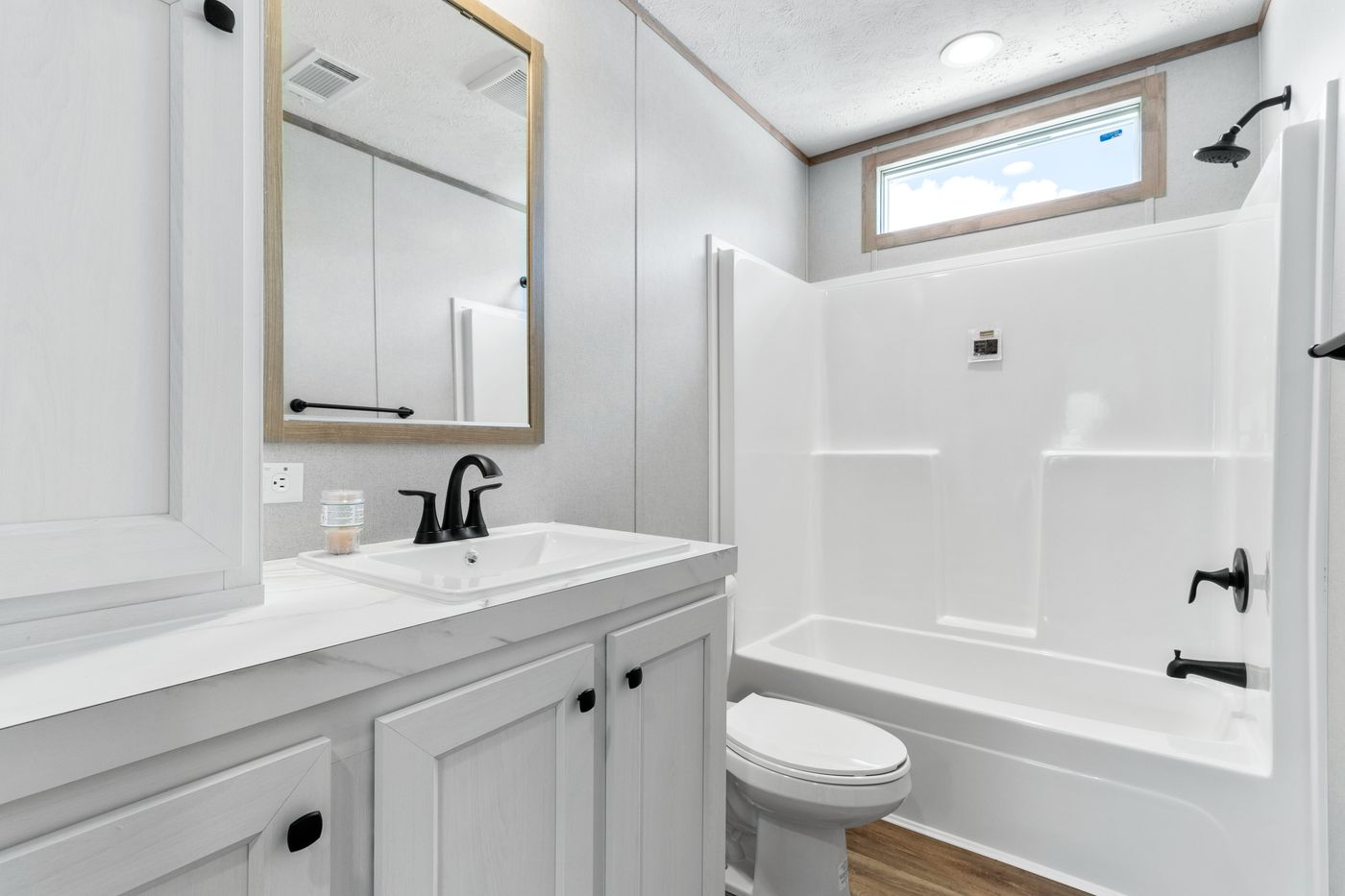 The THE REAL DEAL Guest Bathroom. This Manufactured Mobile Home features 3 bedrooms and 2 baths.