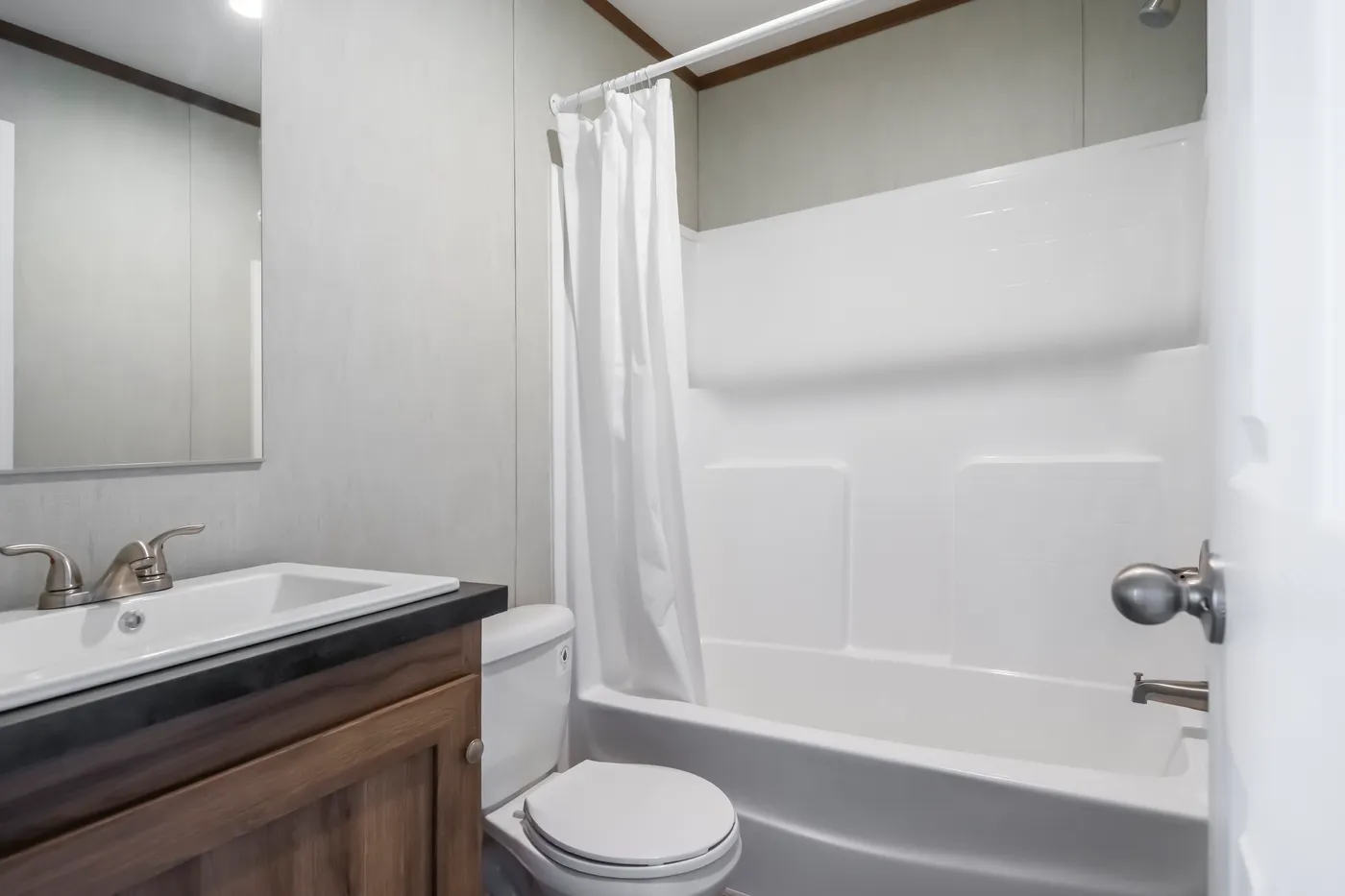 The SEAS THE DAY Guest Bathroom. This Manufactured Mobile Home features 3 bedrooms and 2 baths.