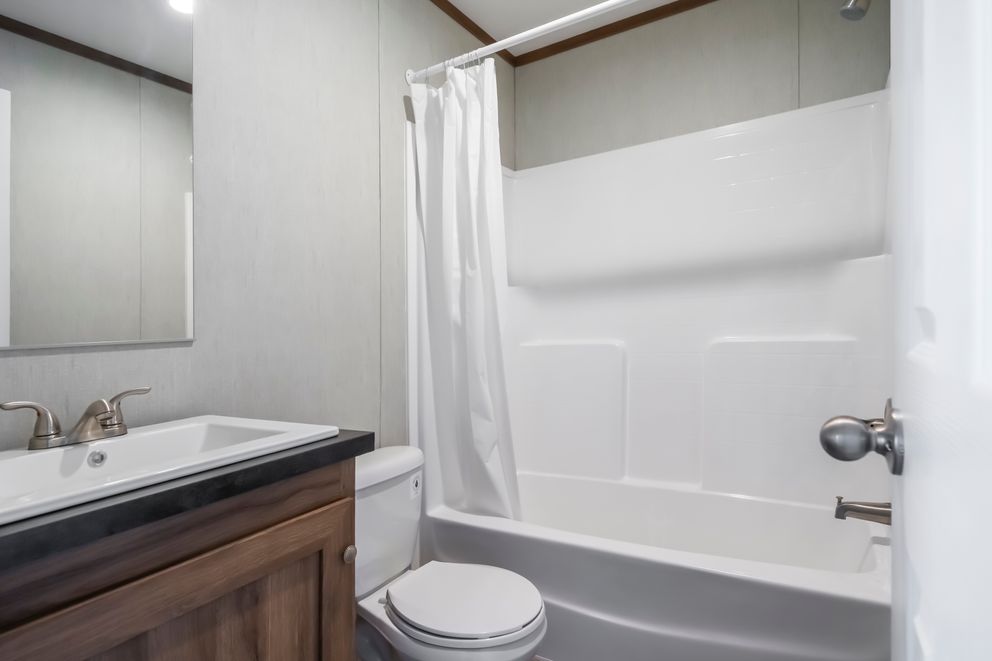 The SEAS THE DAY Guest Bathroom. This Manufactured Mobile Home features 3 bedrooms and 2 baths.