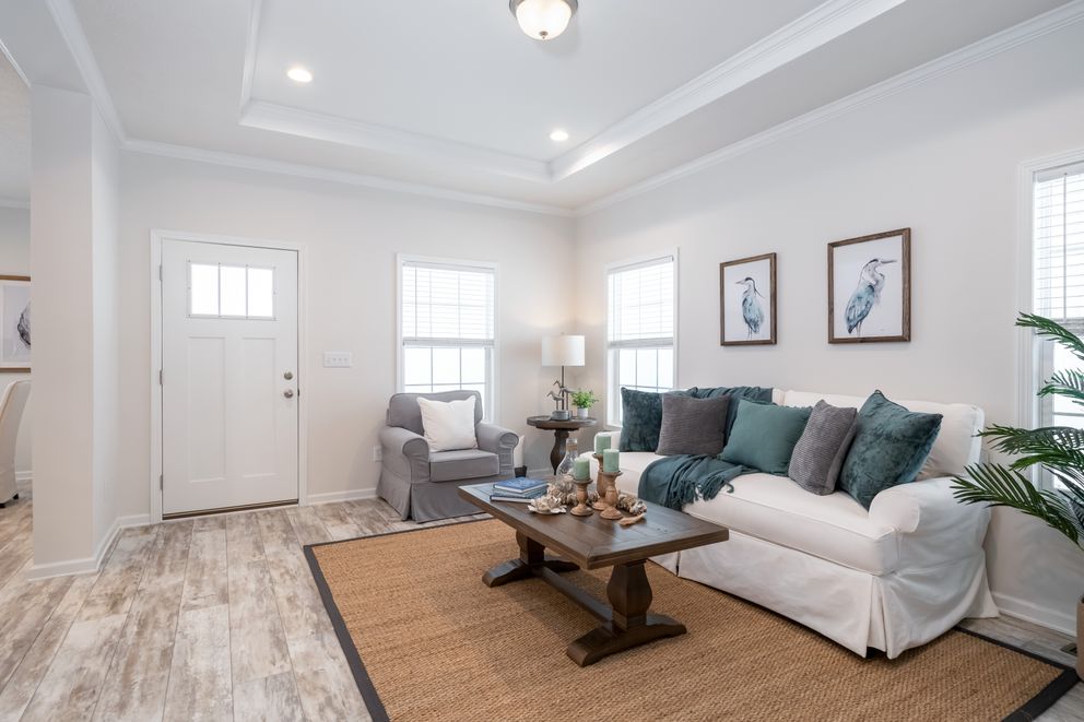 The 2889 THE COTTAGE HUD Living Room. This Manufactured Mobile Home features 3 bedrooms and 2 baths.