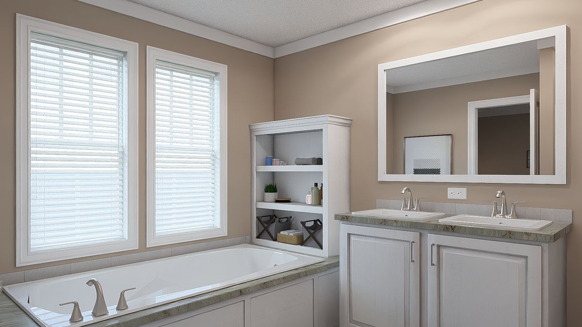 The THE DREAM Primary Bathroom. This Manufactured Mobile Home features 3 bedrooms and 2 baths.