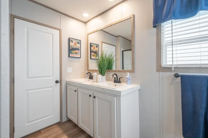 The EL SUENO BREEZE Primary Bathroom. This Manufactured Mobile Home features 4 bedrooms and 2 baths.