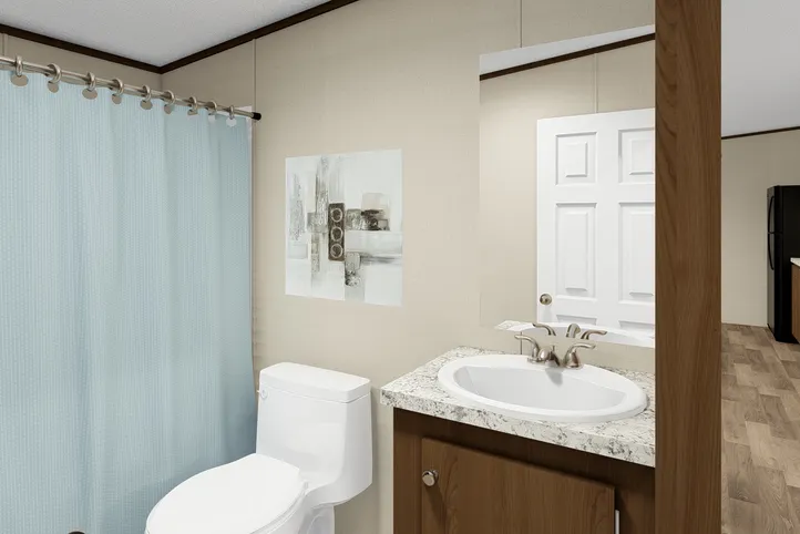 The SATISFACTION Guest Bathroom. This Manufactured Mobile Home features 3 bedrooms and 2 baths.