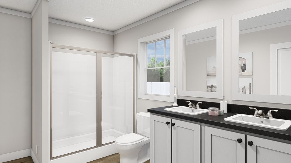 The THREE LITTLE BIRDS Primary Bathroom. This Manufactured Mobile Home features 3 bedrooms and 2 baths.