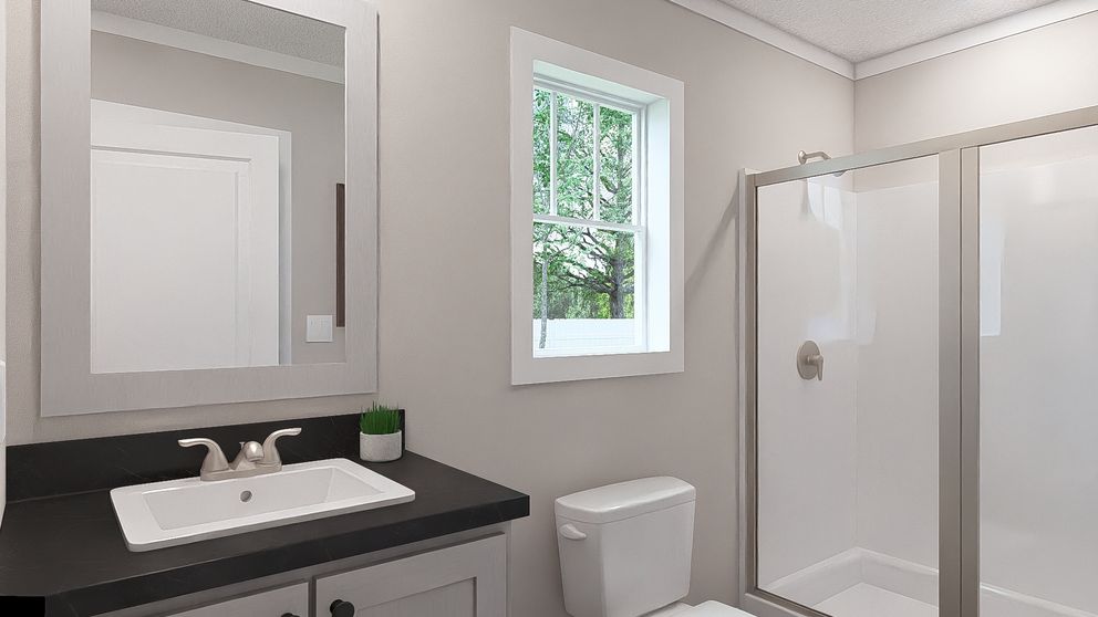 The BORN TO RUN Primary Bathroom. This Manufactured Mobile Home features 2 bedrooms and 2 baths.