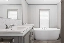 The THE POWERHOUSE Primary Bathroom. This Manufactured Mobile Home features 3 bedrooms and 2 baths.